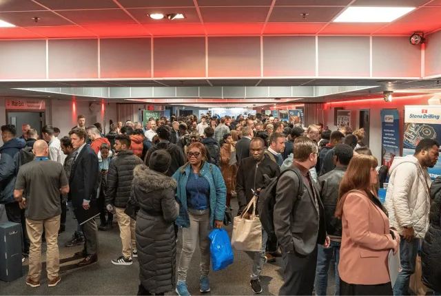 A long hall full of job seekers moving between employer booths